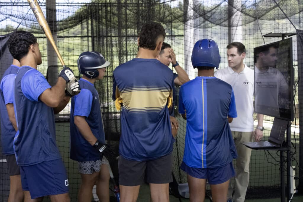 HItTrax team member showing student-athletes how to use the technology. 