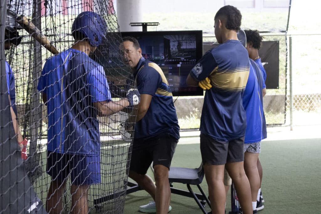 A coach from the Carlos Beltran Baseball Academy using HitTrax to train his student-athletes. 